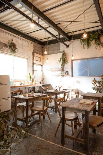 a restaurant with wooden tables and chairs in a room at Exclusive Accommodation 9bicycle 9ppl in Tokyo