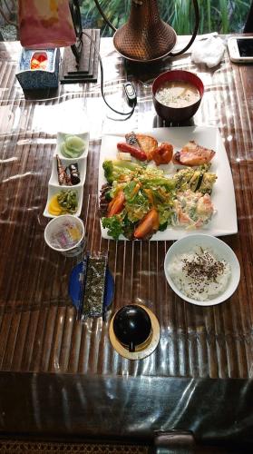 a table with several plates of food on it at Live Cafe Hisui no Umi in Itoigawa
