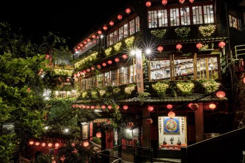 a building with christmas lights on the side of it at 106 Homestay in Ruifang