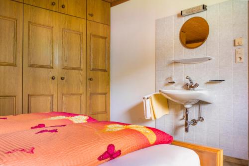 a bedroom with a bed and a sink in it at Chalet Matzhof in Leogang