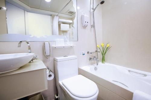 a bathroom with a toilet and a sink and a tub at Harbour Plaza 8 Degrees in Hong Kong