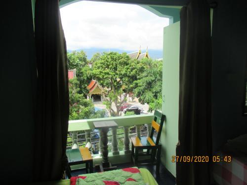 a room with a window with a view of a resort at Jay Guesthouse and Restaurant (adult only) in Chiang Mai