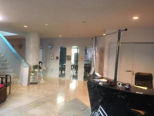 a large living room with a fireplace and stairs at Narita Airport Samurai Hostel in Kujukuri