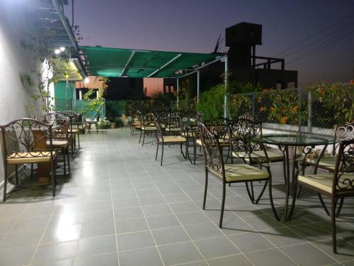 a row of tables and chairs on a patio at Aashiyana Inn in Nashik