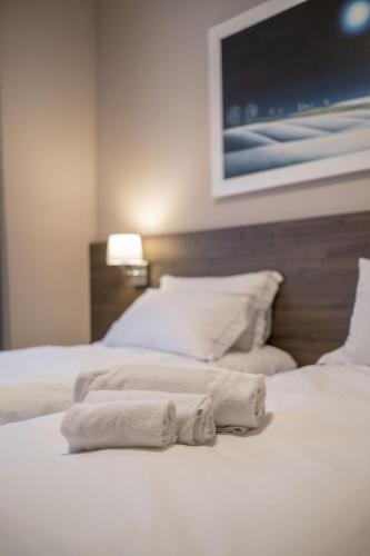 two towels are sitting on top of a bed at Hotel Guerro in Castelvetro di Modena