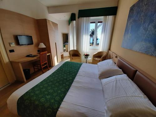 a hotel room with a bed and a desk at Hotel Esperia in Genoa