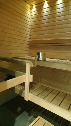 a sauna with a metal bowl on top of it at Apartment Pistoolintie in Pyhäjoki
