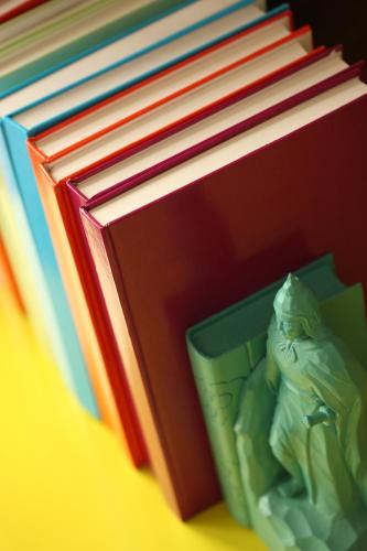 a stack of books with a figurine next to it at Hotel Indigo Xiamen Harbour by IHG in Xiamen
