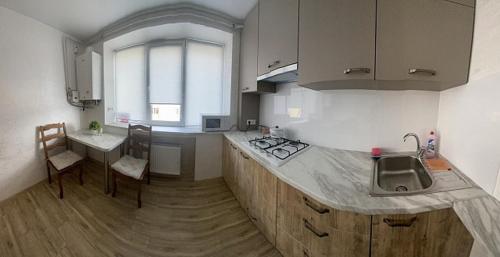 a kitchen with a sink and a counter top at Babylon Apartments on Era 2 in Rivne