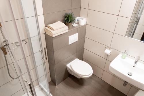 a bathroom with a toilet and a sink and a shower at Restaurace a penzion U Hasičů in Klimkovice