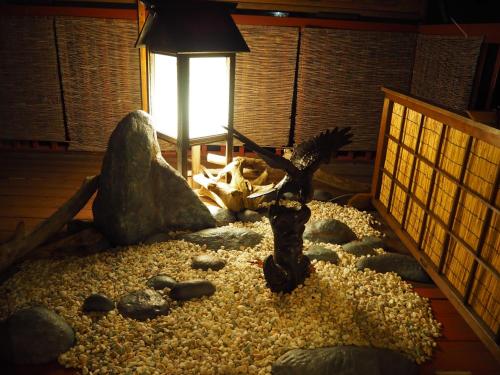 a room filled with rocks and a statue of a goat at 民泊カフェ Gootarian in Kumamoto