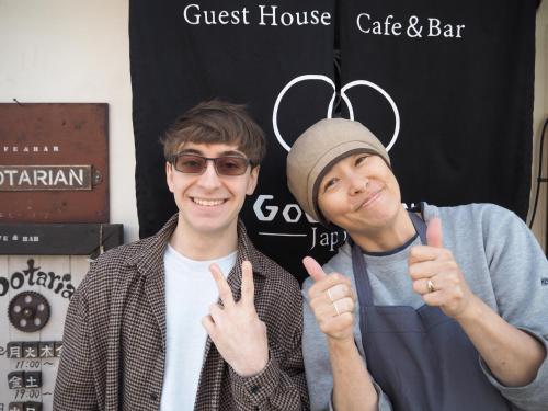 two young men giving the thumbs up sign at 民泊カフェ Gootarian in Kumamoto