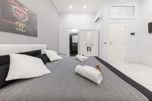 a bedroom with a large bed with white pillows at B&B DEL CORSO in Bari