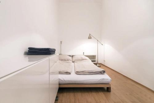 a bed in a room with a glass wall at DESIGN APARTMENT PASETTI in Vienna