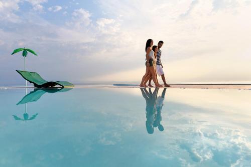 a group of people walking in the water in a pool at Alexandra Elegance Bridging Generations in Potos