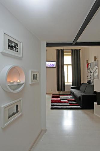 a living room with a couch and a tv at Apartment House - The Modern Flat in Prague