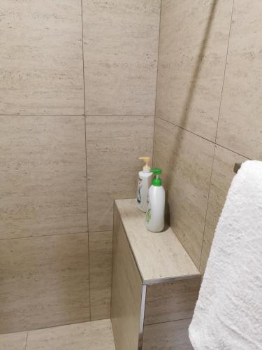 a bathroom with two bottles ofodorizers on a shelf at BHA Unit 6 in Perth