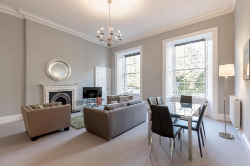 a living room with a couch and a table at Destiny Scotland - Q-Residence in Edinburgh