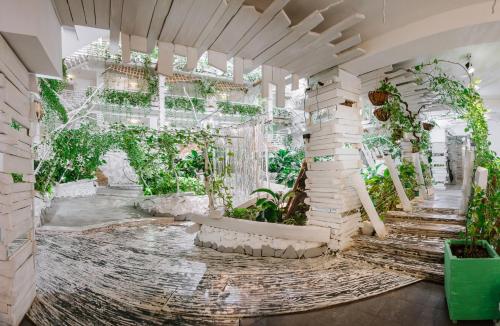an indoor garden with a waterfall and plants at Higina Spa Hotel in Truskavets