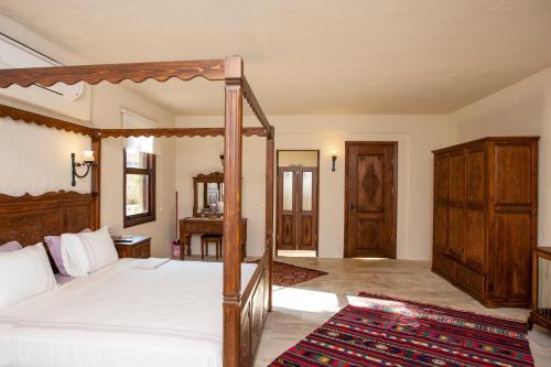 a bedroom with a large bed with a wooden frame at Exclusive Boutique Hotel 3 in Fethiye