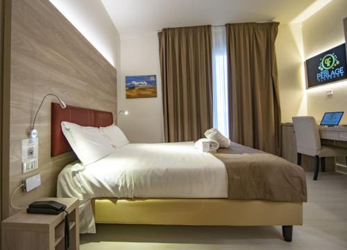 a bedroom with a large bed and a large window at Hotel Perlage Florence in Scandicci