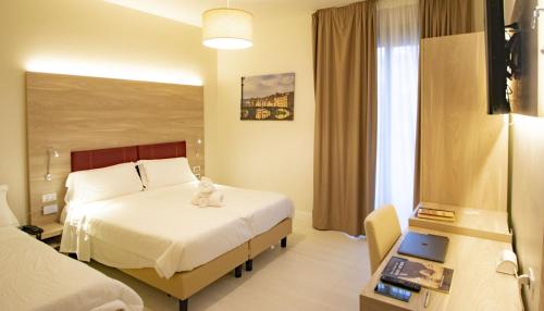 a hotel room with a bed with a teddy bear on it at Hotel Perlage Florence - Free city tax with Private Parking & Fast Wifi in Scandicci