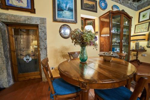 a dining room table with a vase of flowers on it at Alloggio Turistico Centro Storico Malatesta in Montefiascone