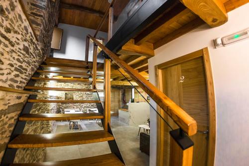 a staircase in a house with wooden beams at Hotel O Pozo in O Pino 