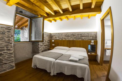a bedroom with a large bed in a room at Hotel O Pozo in O Pino 