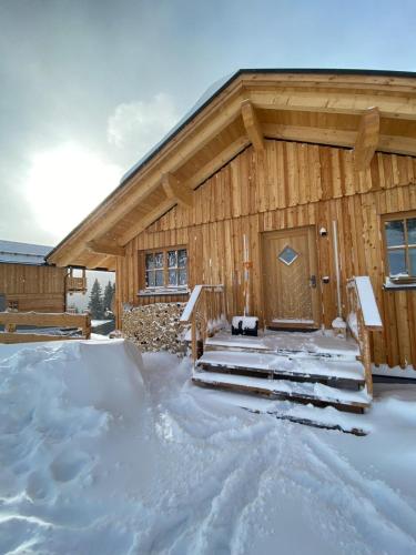 a log cabin with snow in front of it at Almhütte in Lachtal
