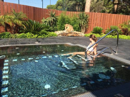 a young girl is in a swimming pool at Mobile Homes by KelAir at Playa Montroig Camping Resort in Tarragona