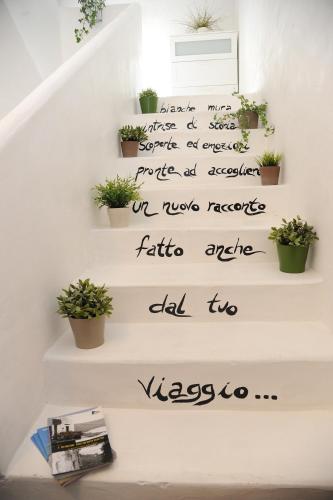 a staircase with plants on it with a sign on it at Matinee Rooms in Mattinata
