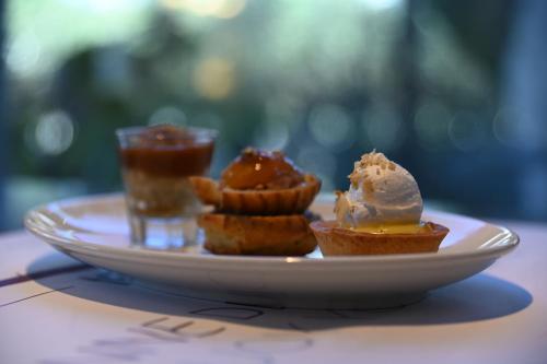 a plate of food with ice cream on a table at Hotel Mercure Alger Aéroport in Dar el Beïda
