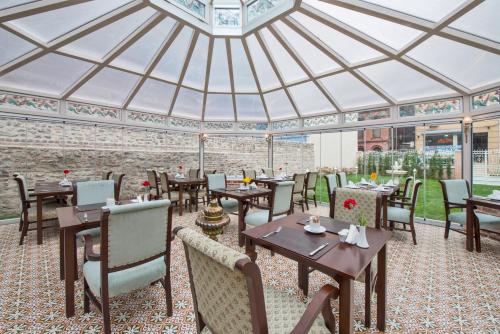 a restaurant with tables and chairs in a domed roof at Enderun Hotel Istanbul in Istanbul
