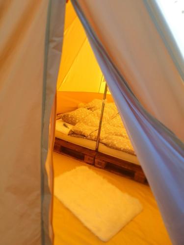 an inside of a tent with a bed in it at Zarevo Glamping in Skobelevo
