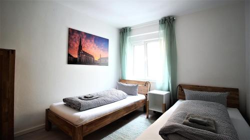 a small bedroom with a bed and a window at central & lovely - for up to 6 persons in Würzburg