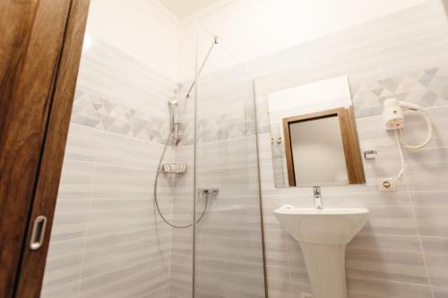 a bathroom with a shower and a toilet and a sink at Nicole in Uzhhorod
