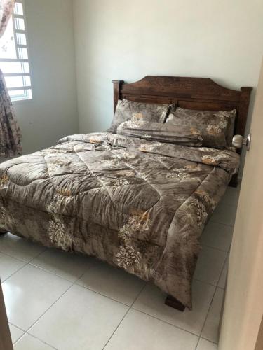 a bed sitting in a bedroom with a sqor sqor at SEROJA HOMESTAY in Melaka