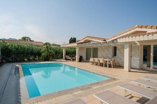 a swimming pool in the backyard of a house at Ville D'Ogliastra in Cardedu