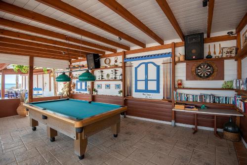 a room with a pool table in a house at Mammis Beach Hotel in Kardamaina