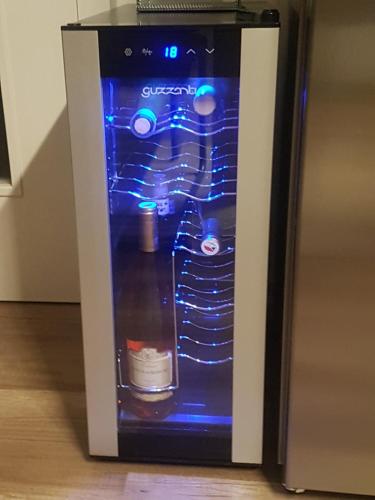 a small refrigerator with blue lights on it at Ubytování U Špačků Pálava in Novosedly
