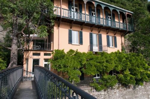 a building with a balcony on top of a fence at Villa Nina Relais Boutique B&B in Carate Urio