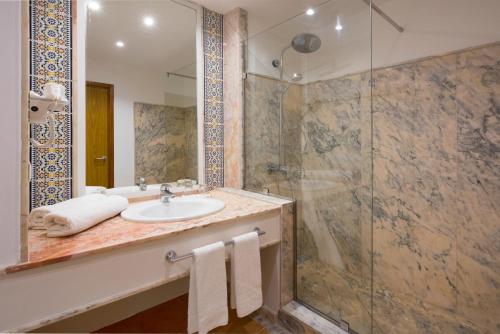 a bathroom with a sink and a shower at Iberostar Waves Founty Beach All Inclusive in Agadir
