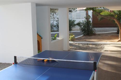 a blue ping pong table sitting in a room at Can Mossènyer in San Antonio
