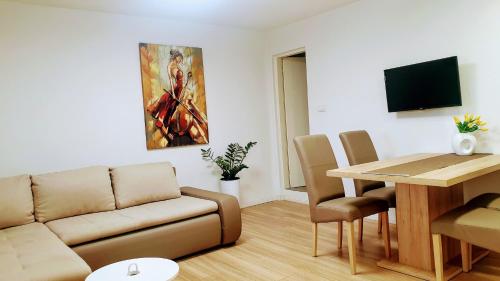 a living room with a couch and a table at Bluesun Sibenik Apartments in Šibenik