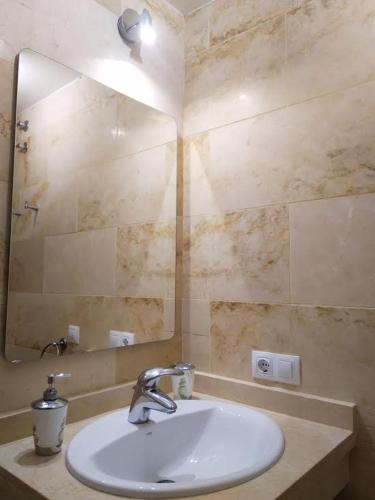 a bathroom with a sink and a mirror at Ocean View Elegant Magic Apartment in Palm-Mar