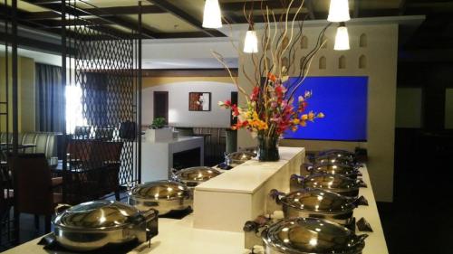 a kitchen with a bunch of pots and pans on a counter at Hotel Abigail Goradia's in Shirdi