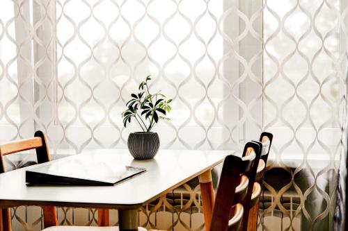 a table with a plant in a vase on it at Aura, City Center, Tartu Home in Tartu