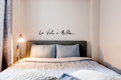 a bedroom with a bed with a sign that reads i was a wild at Aura, City Center, Tartu Home in Tartu