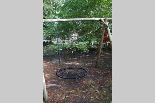 a swing set in a yard with at Kreativ-Kate in Kranenburg